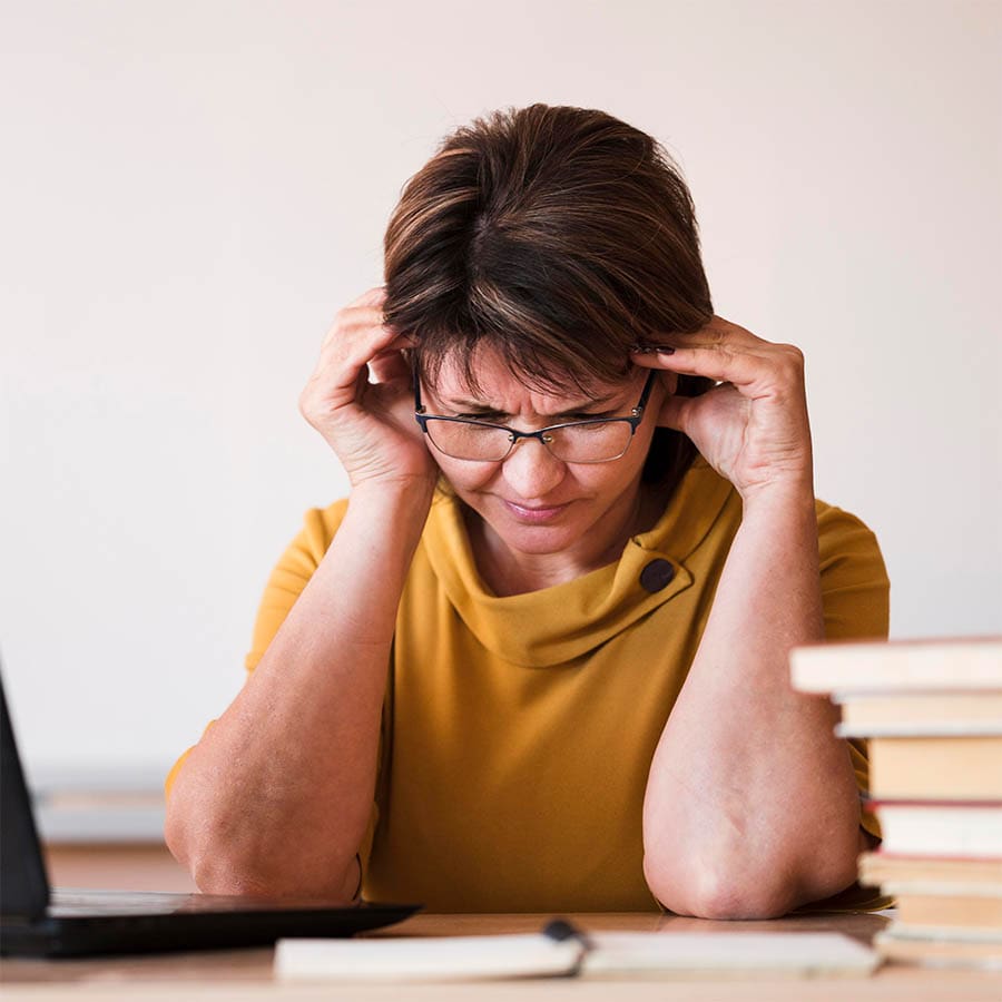 A person looks worried about bills getting paid.